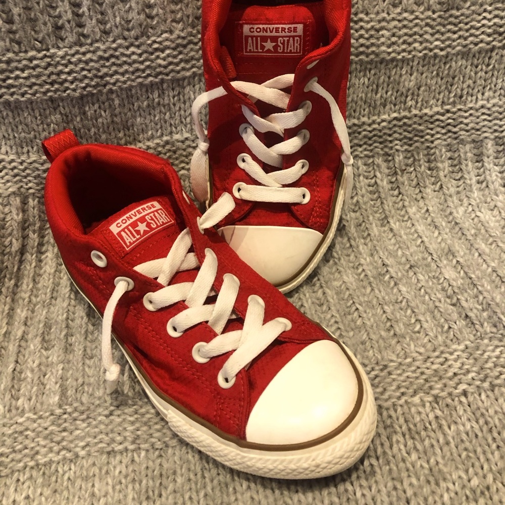 Red worn size five boys all-star Chuck Taylor converse shoes.